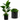 A potted artificial bird of paradise plant with large green leaves in a black faceted geometric pot, shown on a white background with a circular inset detail of the pot and plant.